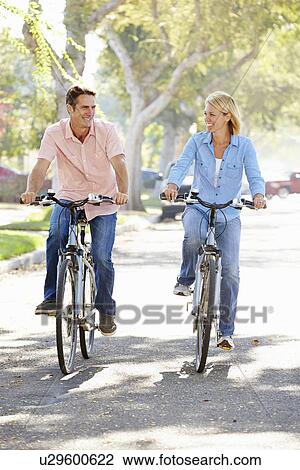 Couple Cycling On Suburban Street View Large Photo Image Stock Image - Couple Cycling On Suburban Street. Fotosearch