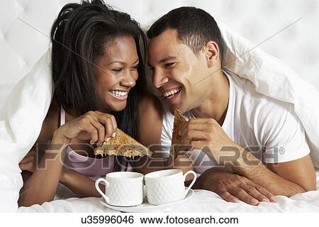 Stock Photograph - Couple Enjoying Breakfast In Bed. Fotosearch