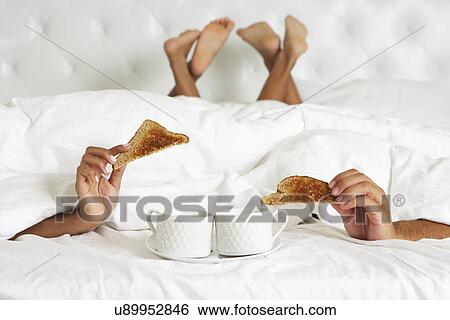 Couple Hiding Under Duvet Enjoying Breakfast In Bed View Large Photo Image Stock Photograph - Couple Hiding Under Duvet Enjoying Breakfast In Bed. Fotosearch