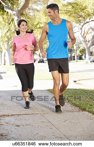 Couple Running On Suburban Street View Large Photo Image Stock Photograph - Couple Running On Suburban Street. Fotosearch