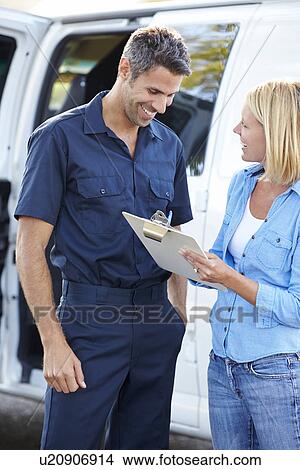 Customer Signing For Delivery From Courier View Large Photo Image Picture - Customer Signing For Delivery From Courier. Fotosearch