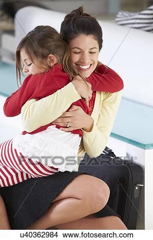 Picture - Daughter Greets Mother On Return From Work. Fotosearch