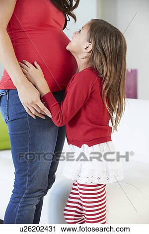 Daughter Listening To Pregnant Mother's Stomach View Large Photo Image Stock Image - Daughter Listening To Pregnant Mother's Stomach. Fotosearch