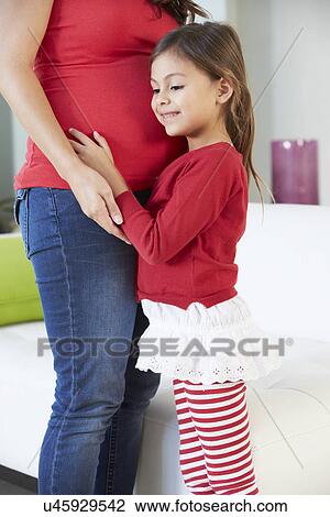 Daughter Listening To Pregnant Mother's Stomach View Large Photo Image Stock Image - Daughter Listening To Pregnant Mother's Stomach. Fotosearch