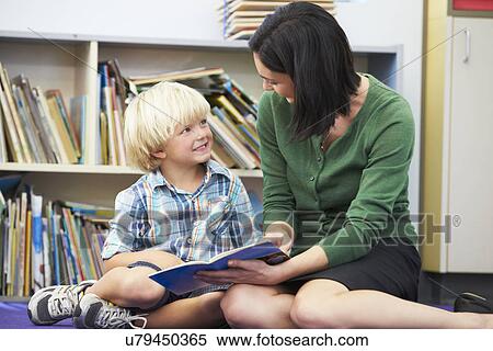 Elementary Pupil Reading With Teacher In Classroom View Large Photo Image Stock Photography - Elementary Pupil Reading With Teacher In Classroom. Fotosearch