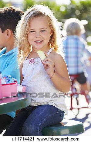 Elementary Pupil Sitting At Table Eating Lunch View Large Photo Image Stock Image - Elementary Pupil Sitting At Table Eating Lunch. Fotosearch