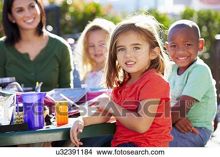 Elementary Pupils And Teacher Eating Lunch View Large Photo Image Picture - Elementary Pupils And Teacher Eating Lunch. Fotosearch