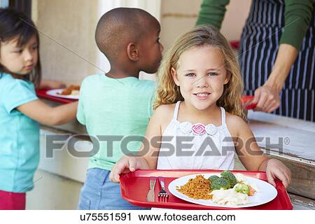 Stock Image - Elementary Pupils Collecting Healthy Lunch In Cafeteria. Fotosearch
