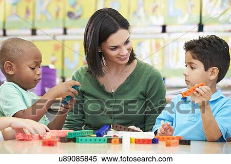 Elementary Pupils Counting With Teacher In Classroom View Large Photo Image Stock Photography - Elementary Pupils Counting With Teacher In Classroom. Fotosearch