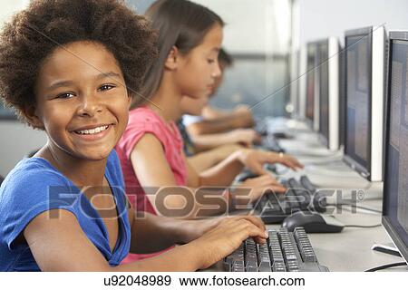 Elementary Students Working At Computers In Classroom View Large Photo Image Stock Photo - Elementary Students Working At Computers In Classroom. Fotosearch