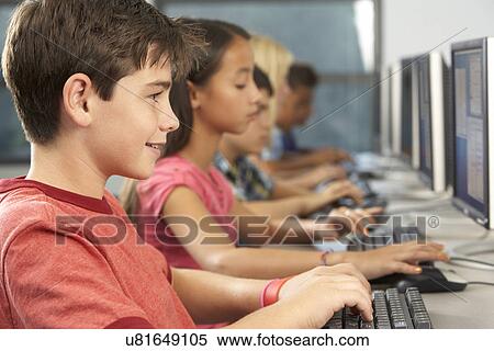 Stock Photography - Elementary Students Working At Computers In Classroom. Fotosearch