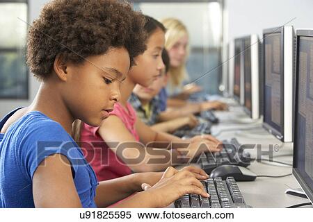 Stock Photography - Elementary Students Working At Computers In Classroom. Fotosearch