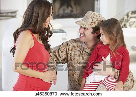 Stock Image - Family Greeting Military Father Home On Leave. Fotosearch