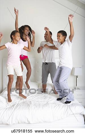Family Jumping On Bed Together View Large Photo Image Stock Photography - Family Jumping On Bed Together. Fotosearch