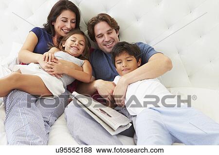 Family Relaxing In Bed With Coffee And Newspaper View Large Photo Image Stock Photo - Family Relaxing In Bed With Coffee And Newspaper. Fotosearch