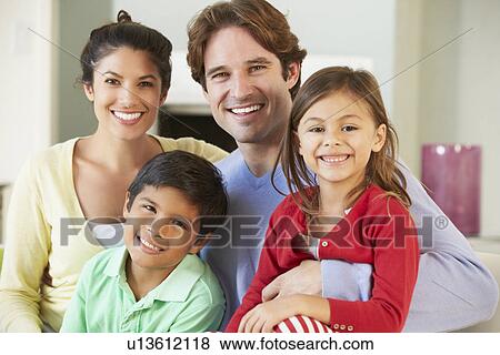 Stock Photo - Family Relaxing On Sofa Together. Fotosearch