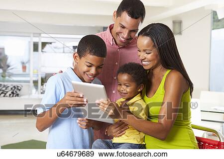 Family Using Digital Tablet In Kitchen Together View Large Photo Image Stock Photo - Family Using Digital Tablet In Kitchen Together. Fotosearch
