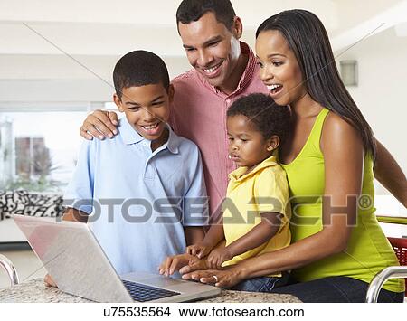 Family Using Laptop In Kitchen Together View Large Photo Image Picture - Family Using Laptop In Kitchen Together. Fotosearch