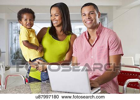 Family Using Laptop In Kitchen Together View Large Photo Image Stock Image - Family Using Laptop In Kitchen Together. Fotosearch