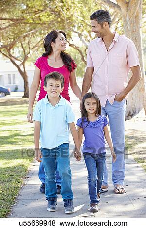 Stock Photo - Family Walking Along Suburban Street. Fotosearch