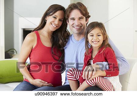 Family With Pregnant Mother Relaxing On Sofa Together View Large Photo Image Stock Photo - Family With Pregnant Mother Relaxing On Sofa Together. Fotosearch