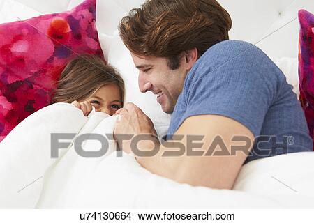 Father And Daughter Lying In Bed Together View Large Photo Image Picture - Father And Daughter Lying In Bed Together. Fotosearch