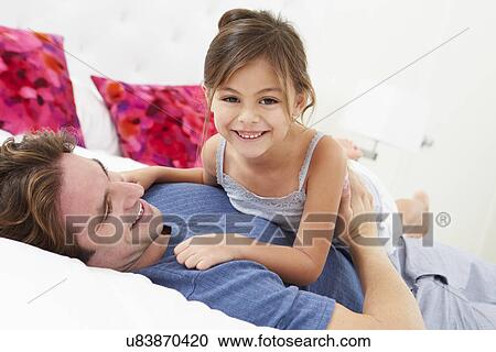 Father And Daughter Lying In Bed Together View Large Photo Image Stock Image - Father And Daughter Lying In Bed Together. Fotosearch