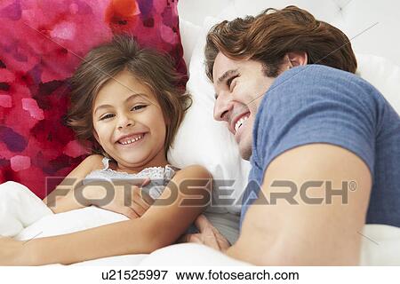 Father And Daughter Lying In Bed Together View Large Photo Image Stock Photo - Father And Daughter Lying In Bed Together. Fotosearch