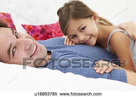 Father And Daughter Lying In Bed Together View Large Photo Image Stock Photography - Father And Daughter Lying In Bed Together. Fotosearch