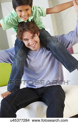 Father And Son Having Fun On Sofa Together View Large Photo Image Picture - Father And Son Having Fun On Sofa Together. Fotosearch