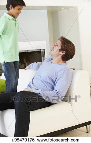 Father And Son Having Fun On Sofa Together View Large Photo Image Stock Photograph - Father And Son Having Fun On Sofa Together. Fotosearch