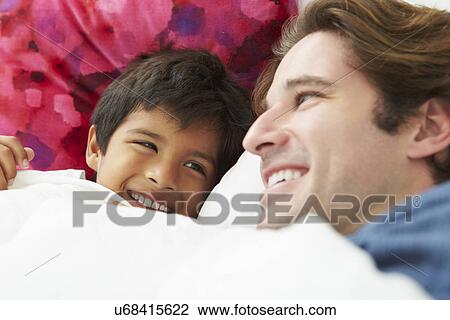 Father And Son Lying In Bed Together View Large Photo Image Stock Image - Father And Son Lying In Bed Together. Fotosearch