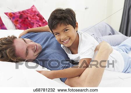 Father And Son Lying In Bed Together View Large Photo Image Stock Image - Father And Son Lying In Bed Together. Fotosearch