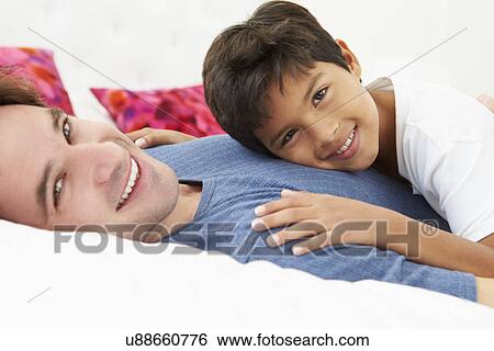 Father And Son Lying In Bed Together View Large Photo Image Stock Photograph - Father And Son Lying In Bed Together. Fotosearch