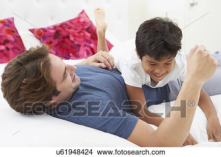 Father And Son Playing In Bed Together View Large Photo Image Picture - Father And Son Playing In Bed Together. Fotosearch