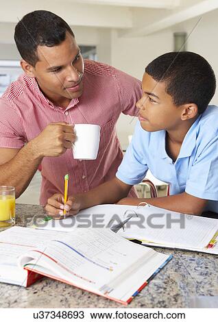 Father Helping Son With Homework In Kitchen View Large Photo Image Stock Image - Father Helping Son With Homework In Kitchen. Fotosearch