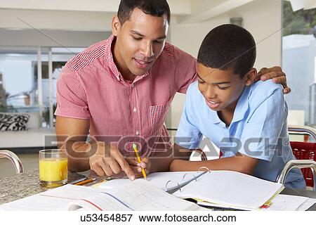Father Helping Son With Homework In Kitchen View Large Photo Image Stock Photo - Father Helping Son With Homework In Kitchen. Fotosearch