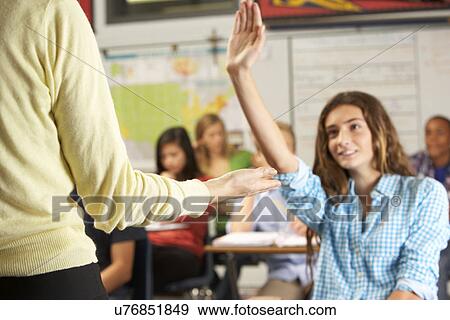 Female Pupil Answering Question In Classroom View Large Photo Image Stock Photo - Female Pupil Answering Question In Classroom. Fotosearch