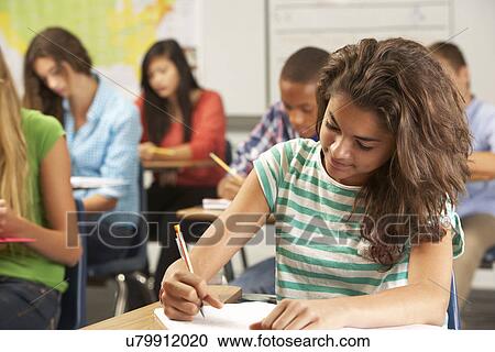 Female Pupil Studying At Desk In Classroom View Large Photo Image Stock Image - Female Pupil Studying At Desk In Classroom. Fotosearch