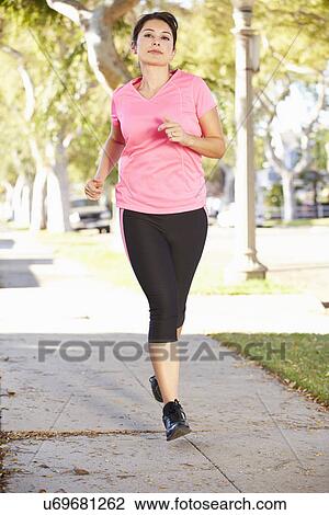 Female Runner Exercising On Suburban Street View Large Photo Image Stock Image - Female Runner Exercising On Suburban Street. Fotosearch