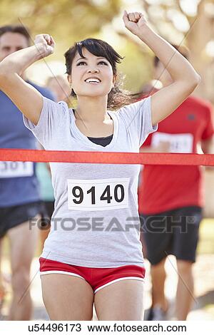 Stock Image - Female Runner Winning Marathon. Fotosearch