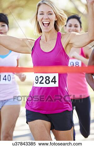 Stock Photography - Female Runner Winning Marathon. Fotosearch