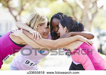 Stock Photo - Female Runners Congratulating One Another After Race. Fotosearch