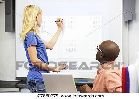 Stock Photo - Female Student Writing Answer On Whiteboard. Fotosearch