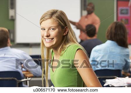 Stock Image - Female Teenage Pupil In Classroom. Fotosearch