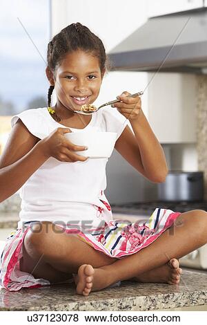 Girl In Kitchen Eating Bowl Of Breakfast Cereal View Large Photo Image Stock Photo - Girl In Kitchen Eating Bowl Of Breakfast Cereal. Fotosearch
