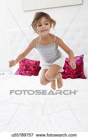 Girl Jumping On Bed Wearing Pajamas View Large Photo Image Stock Photo - Girl Jumping On Bed Wearing Pajamas. Fotosearch