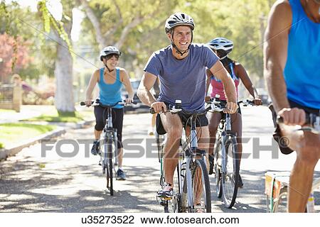 Stock Image - Group Of Cyclists On Suburban Street. Fotosearch