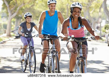 Group Of Cyclists On Suburban Street View Large Photo Image Stock Photograph - Group Of Cyclists On Suburban Street. Fotosearch