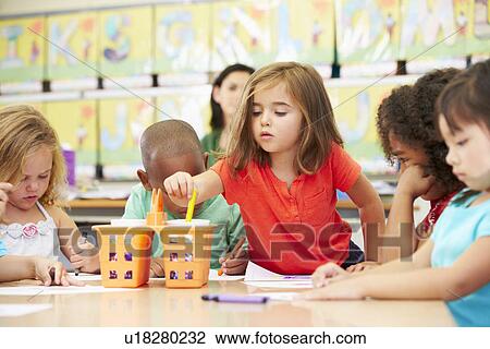Stock Image - Group Of Elementary Age Children In Art Class With Teacher. Fotosearch